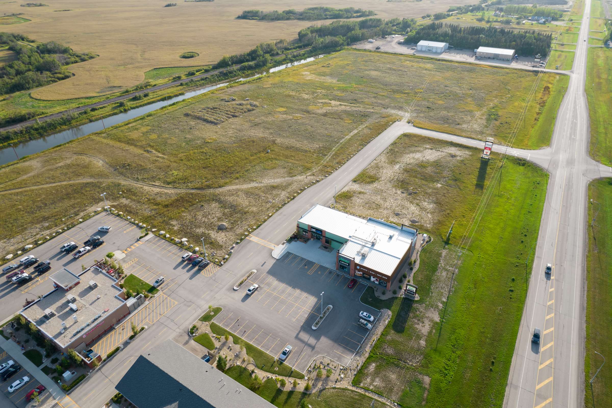 Open land and established businesses beside Highway 5 West at Quill Centre